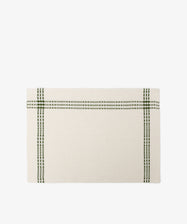 The Tilde Placemat, Set of 6 features rectangular beige mats made from a cotton-linen blend with two intersecting green plaid lines near the edges in a classic Daldräll pattern, shown on a white background.