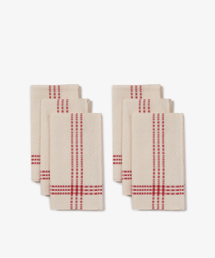 The Tilde Napkin Set of 6 features beige cotton-linen napkins with red stripes, neatly folded and arranged in two groups against a white background.