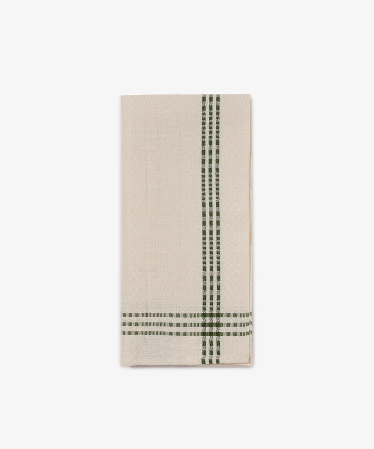 The Tilde Tea Towel is a beige cotton-linen blend with green checkered edges, featuring the classic Swedish Insjöns Daldräll pattern.