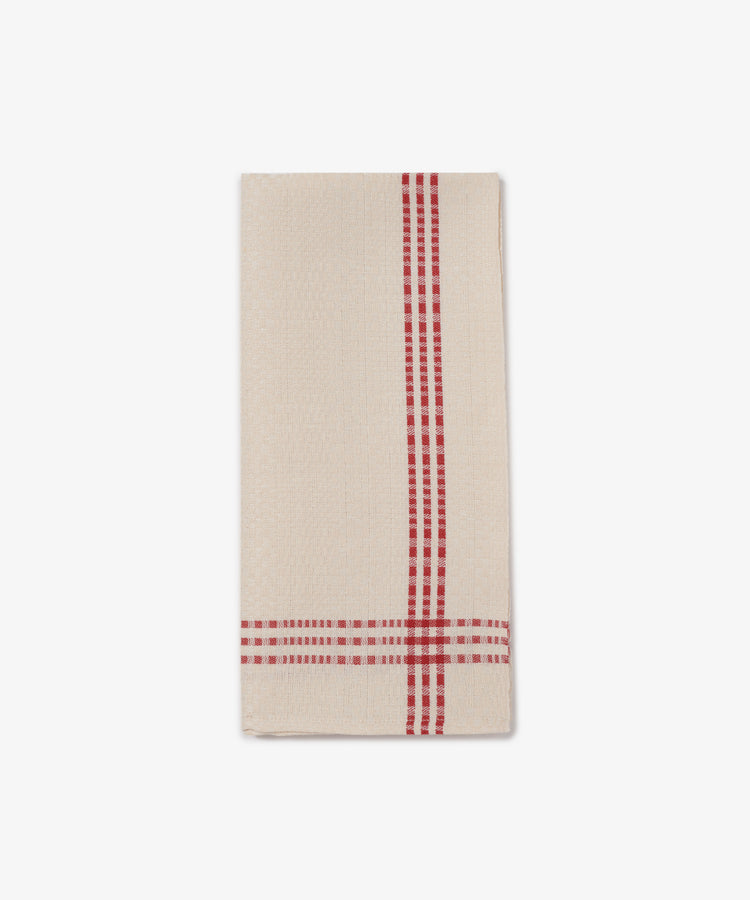 The Tilde Tea Towel, crafted from a cotton and linen blend in the traditional Daldräll pattern, features beige fabric with red plaid stripes along one edge, and is neatly folded on a white background.