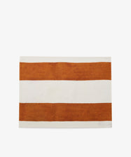 Riga Placemat. Folded white linen mat with thick rust stripes.