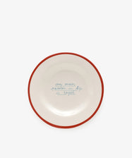 The My main passion in life is bagel plate by Laetitia Rouget is handmade, white with a red rim, and features blue handwritten text in the center.