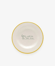 The Honey, youre the bees knees plate is a white ceramic dish with a yellow rim and cursive text, showcasing Laetitia Rouget’s handmade charm.