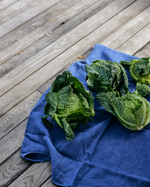 green cabbage and blue linen on wood porch deck