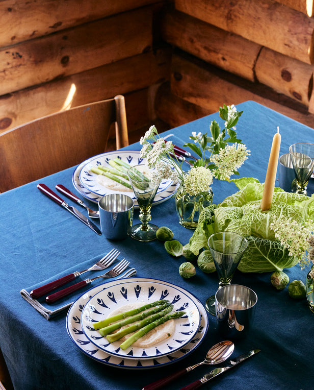 table with plates and vegetable centerpiece