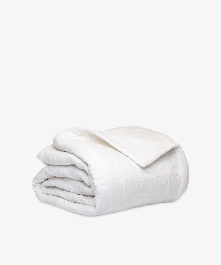 The Dawn Twin Bedspread, shown folded on a white background, features a subtle textured pattern—a tribute to Swedish craftsmanship that adds timeless elegance to any interior design.