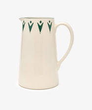 The Vito Jug is a cream ceramic piece featuring a curved handle and dark green geometric designs near the rim—ideal for those who love distinctive glassware.