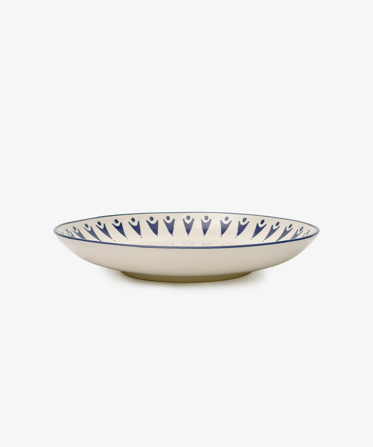 The Vito Serving Platter features a cream base with a blue geometric rim, offering understated style and photographed on a white background.