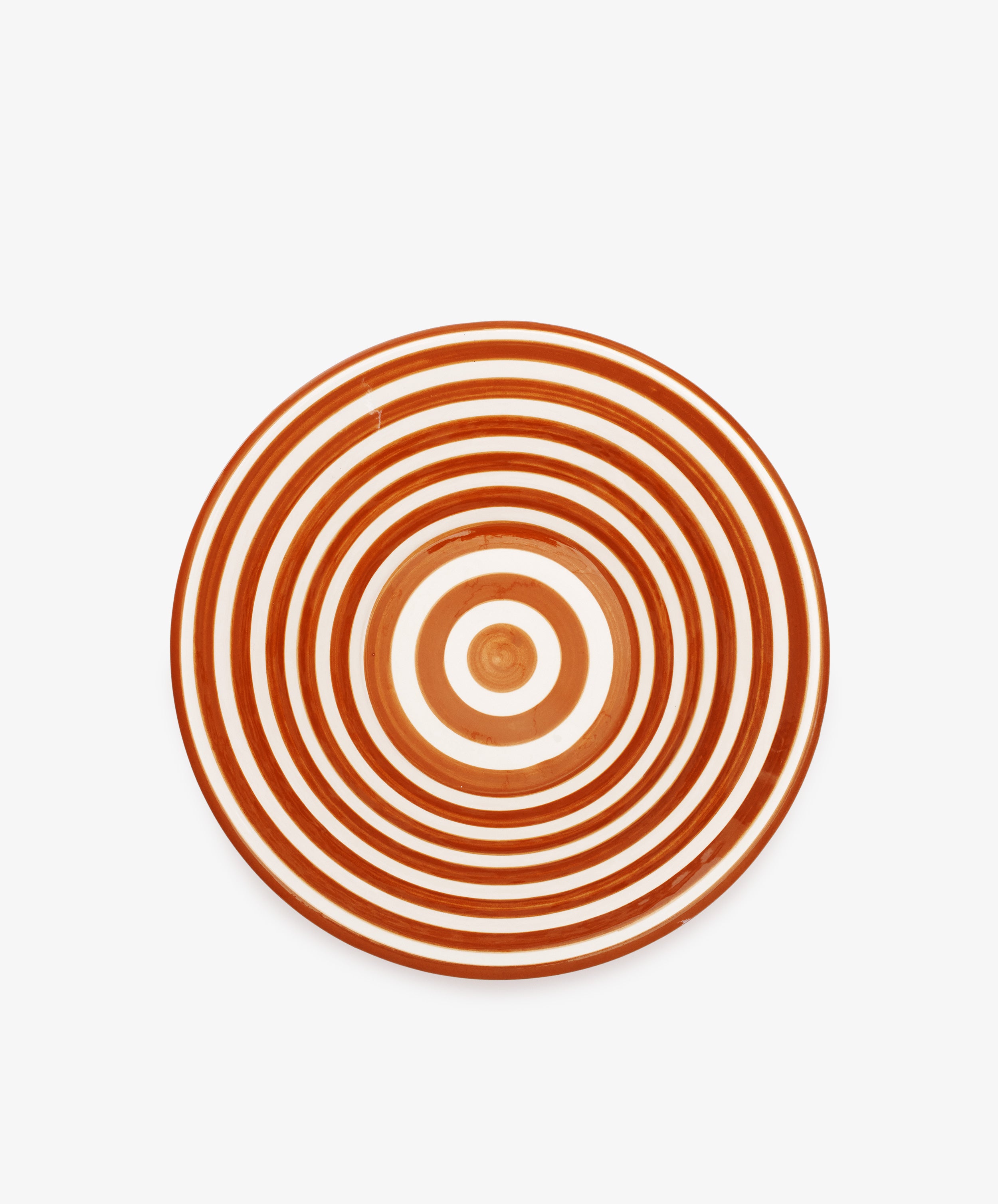 The Natalia Serving Bowl is a round, handmade piece with concentric red and white rings on a white background—ideal as a gift or for pairing with your favorite striped bowl.
