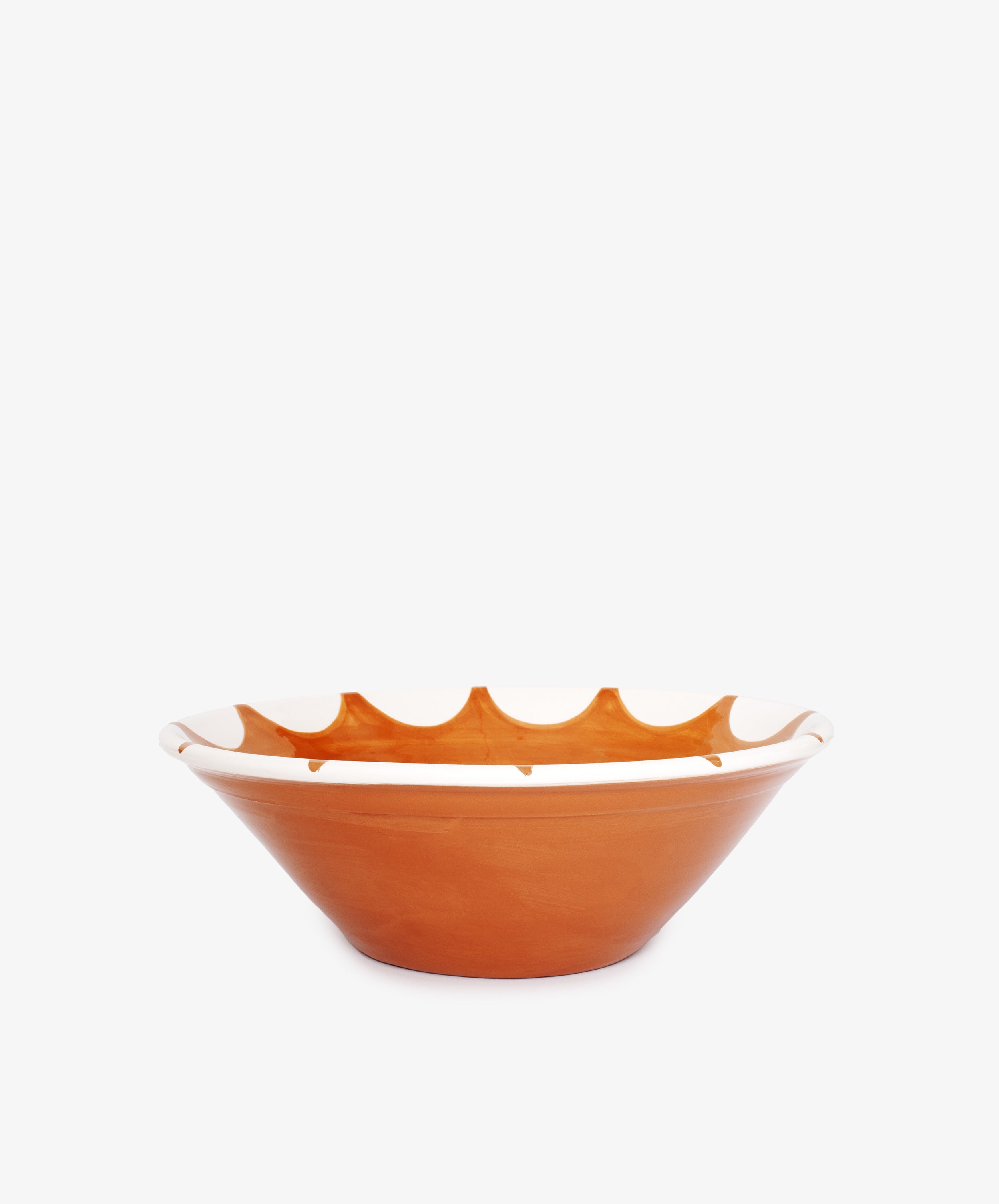 The Stella Serving Bowl is a brown ceramic bowl with a wide, shallow shape and a white star design near the rim, shown against a plain white background.