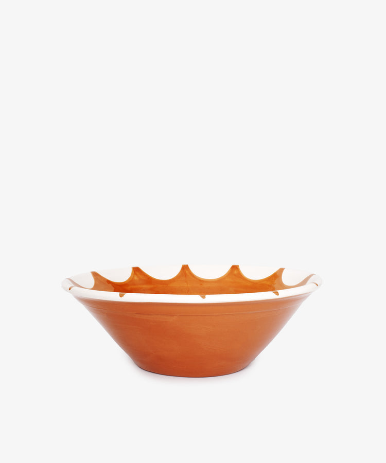 The Stella Serving Bowl is a brown ceramic bowl with a wide, shallow shape and a white star design near the rim, shown against a plain white background.