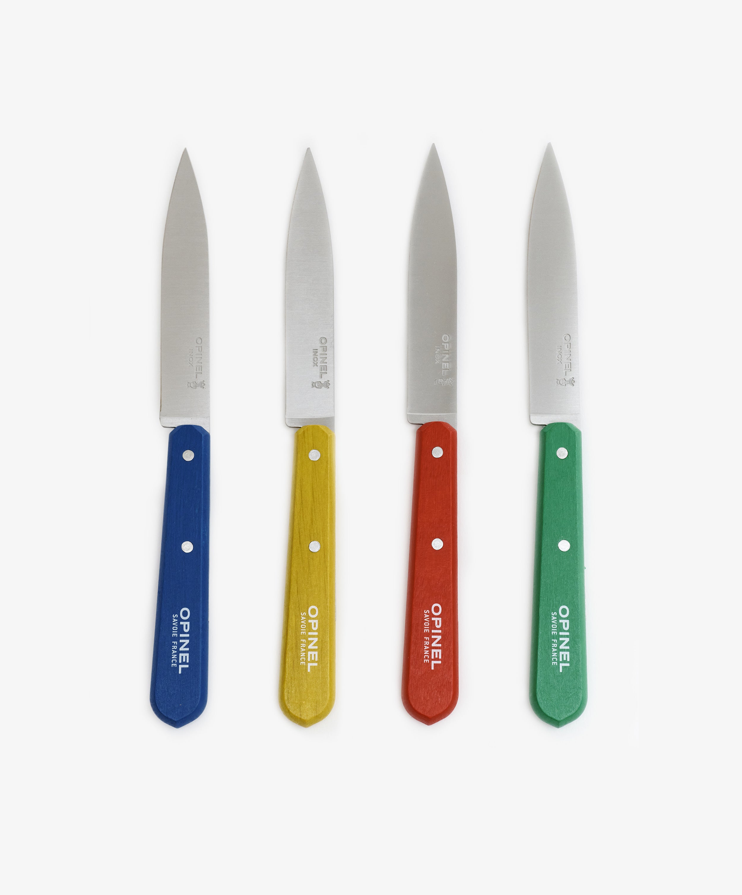The Classic Paring Knives, Set of 4, features stainless steel blades and blue, yellow, red, and green wooden handles—arranged upright on a white background—perfect for small kitchen tasks.