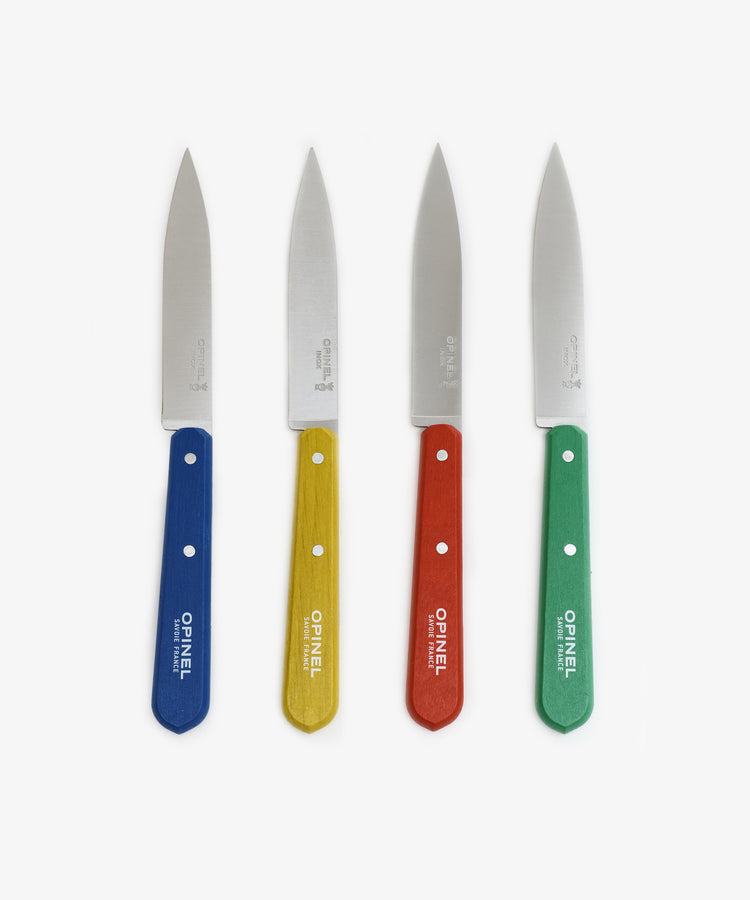 The Classic Paring Knives, Set of 4, features stainless steel blades and blue, yellow, red, and green wooden handles—arranged upright on a white background—perfect for small kitchen tasks.