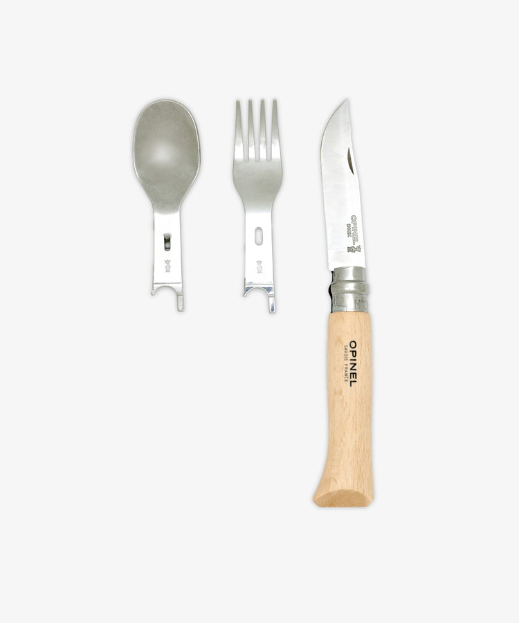The Picnic Plus & Knife, Set of 2 features a reusable metal spoon and fork with slotted handles placed next to a wooden-handled folding knife—an ideal on-the-go cutlery set—displayed against a plain white background.