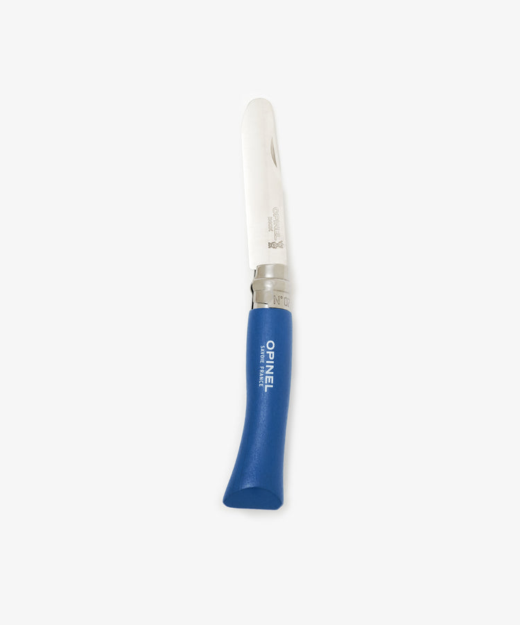 The Primo Kids Knife, a French folding knife with a rounded stainless steel blade, blue handle marked Opinel France, and safety locking ring, is shown against a plain white background.