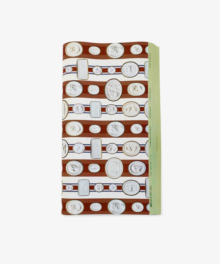 The Intaglio Stripe Gift Wrap features a brown and white pattern of classical cameo portraits in rows, accented by a light green edge for an elegant neoclassical look.