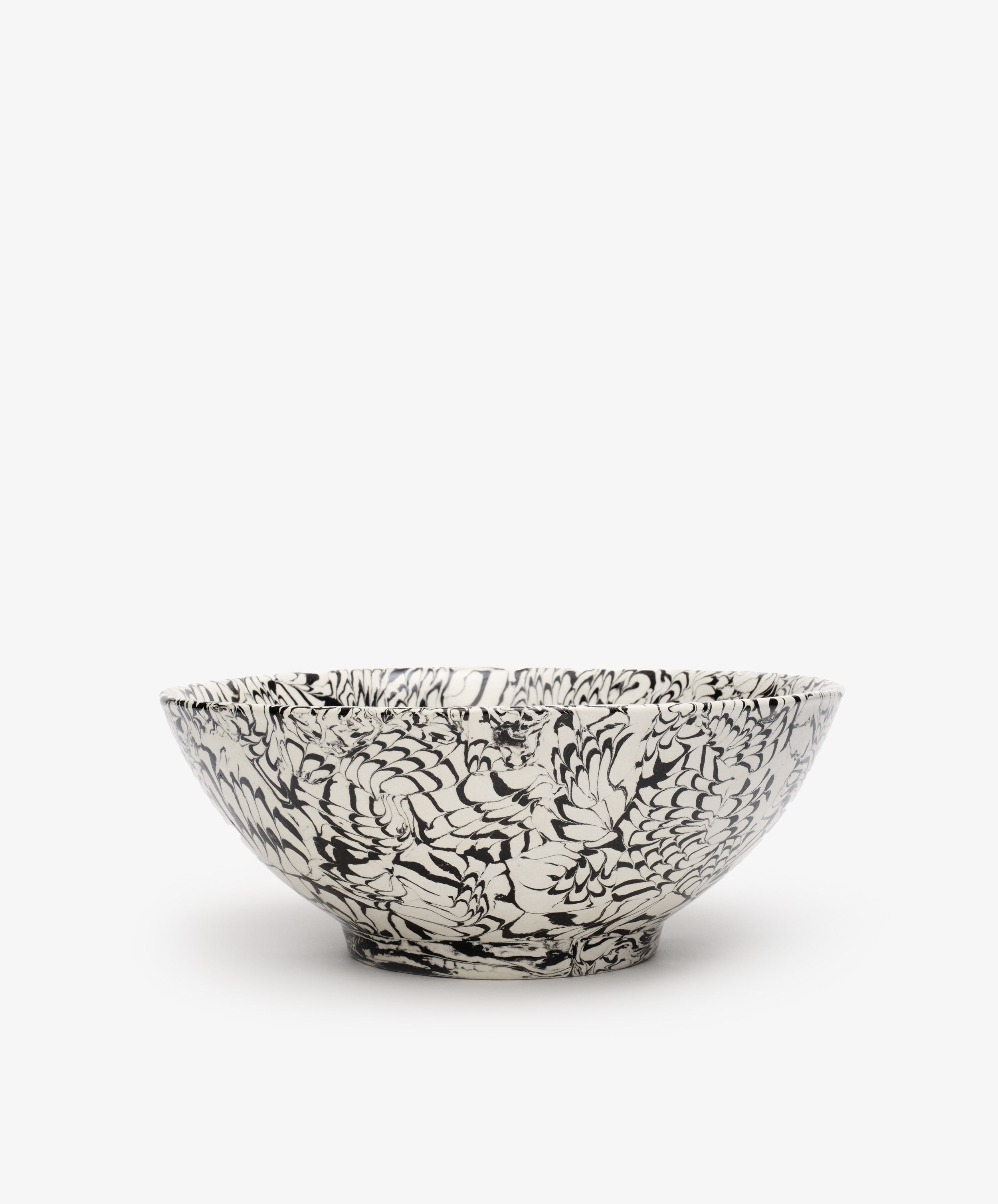 The Celine Salad Bowl features a black and white floral pattern in iconic serveware style, showcased against a plain white background.