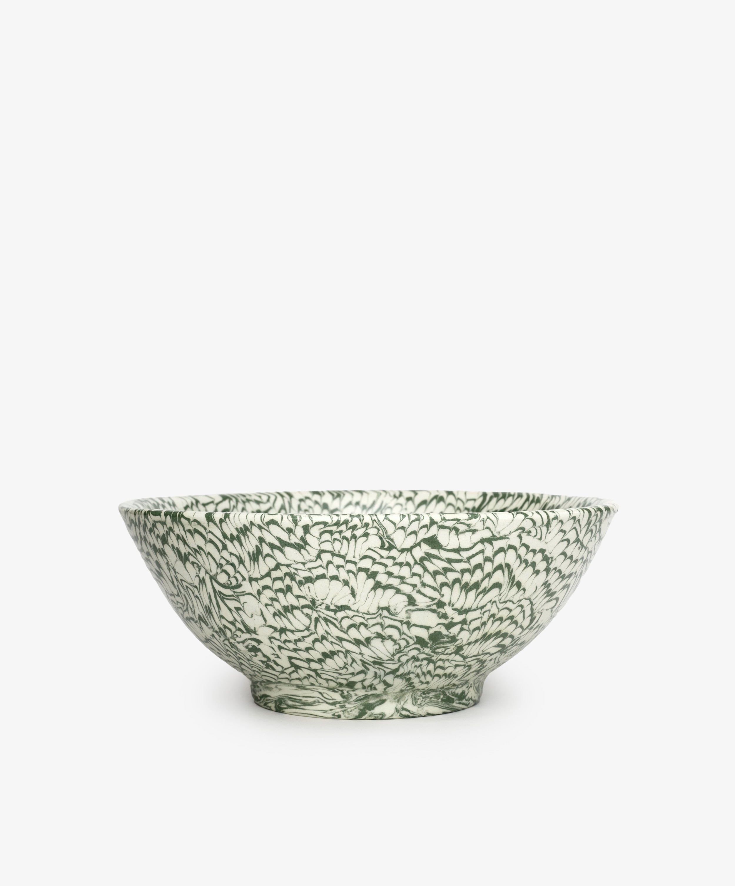 The Celine Salad Bowl is a handcrafted ceramic bowl featuring an intricate green and white floral pattern, set against a plain white background.