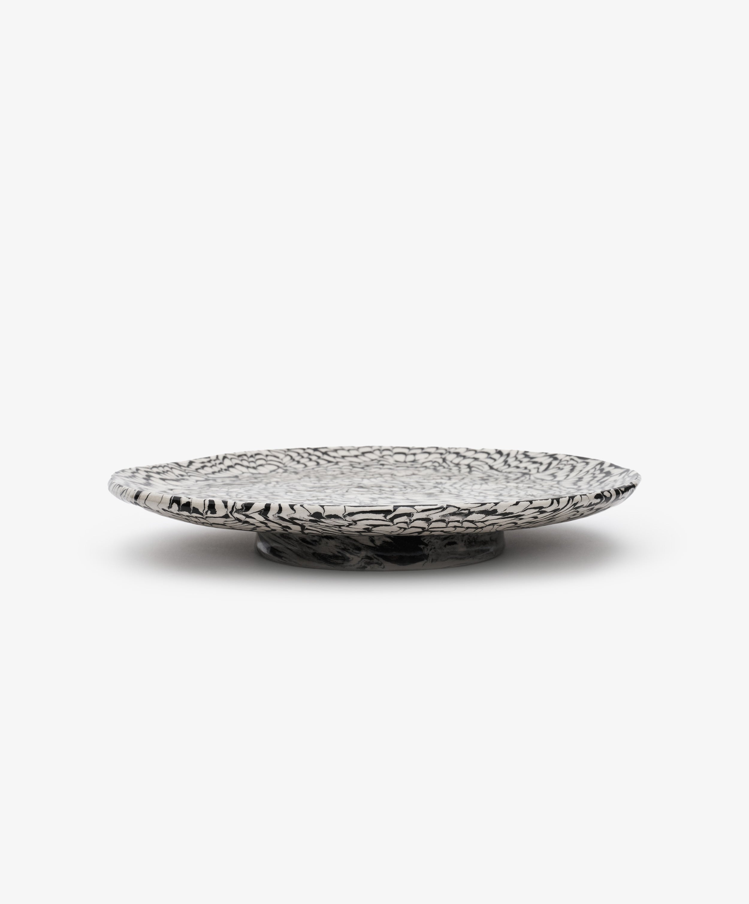 Black and white swirl platter, side view.