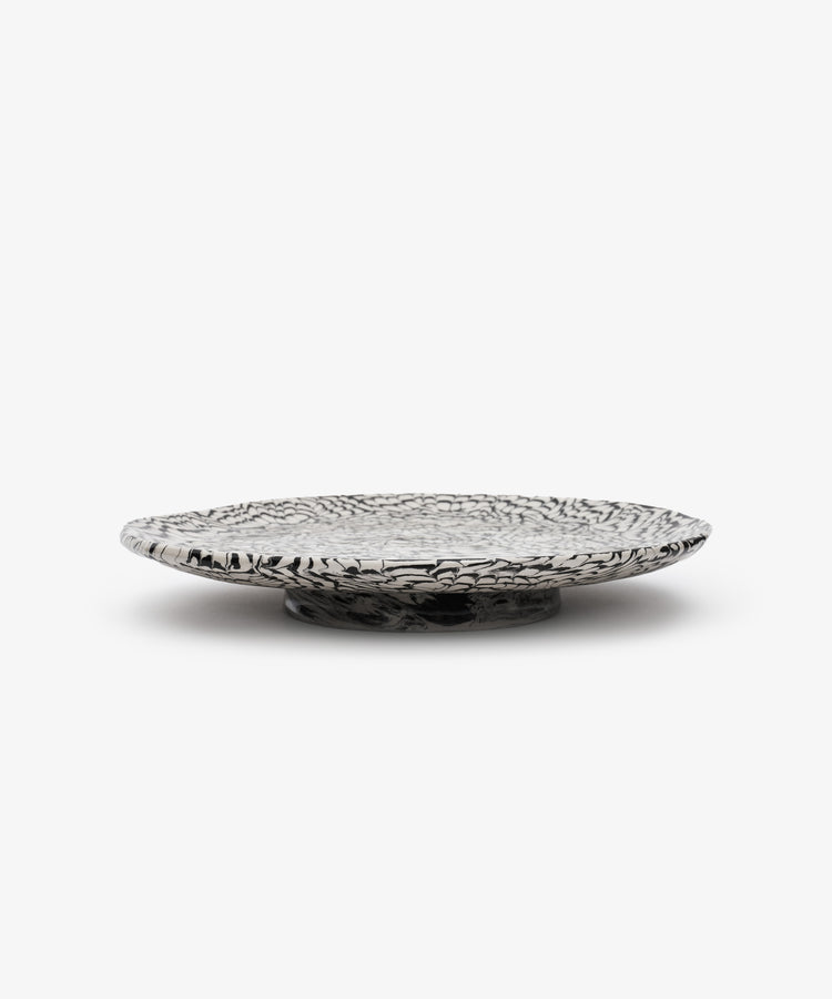 Black and white swirl platter, side view.