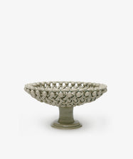Decorative ceramic bowl with textured surface on a white background