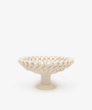 The Remi Footed Bowl features a white ceramic pedestal and open lattice design with hand-braided clay details—an elegant decorative fruit bowl or sculptural accent for any tabletop.