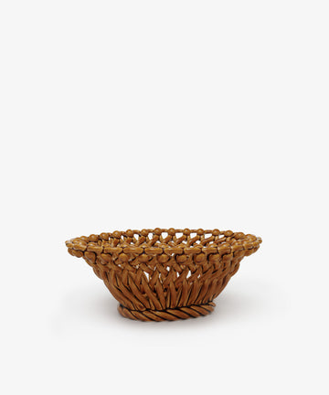 The Remi Decorative Fruit Bowl is a brown woven wicker basket with an open, round shape, shown against a plain white background.