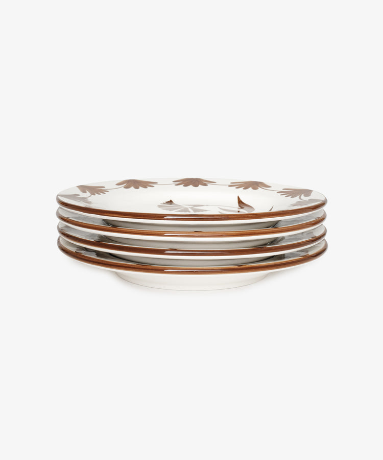 A side view of the Catalina Dinner Plate, Set of 4—handmade ceramic plates featuring brown leaf details and espresso floral rim patterns—displayed against a white background.