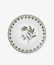 The Esmeralda Serving Bowl is a white, hand-painted ceramic piece featuring a green floral center and decorative green border on the rim, crafted in Portugal.