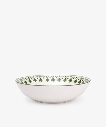 The Esmeralda Serving Bowl is a white ceramic piece from Portugal with a hand-painted green leaf pattern along the inner rim, shown on a plain white background.