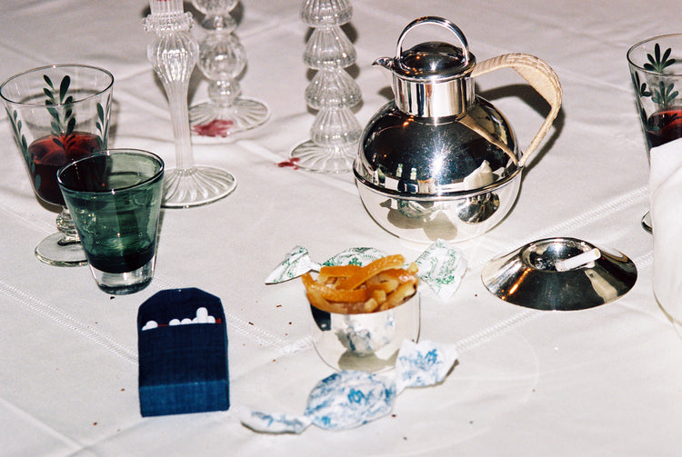 silver tea kettle and silverware on table