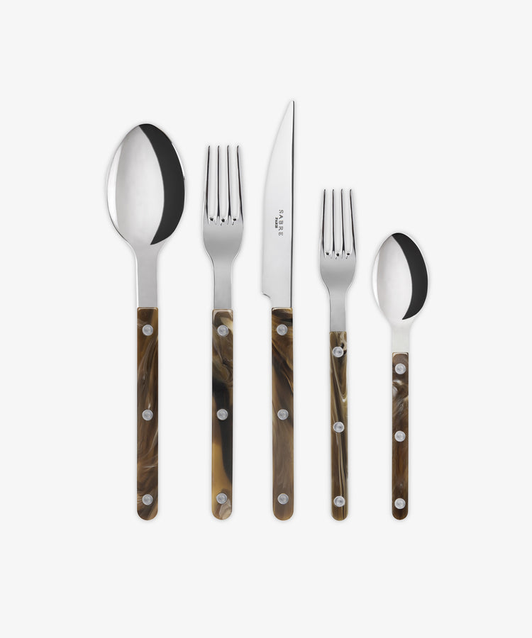 The Bistrot 5 Piece Cutlery Set features silver utensils with brown, marbled buffalo handles and includes a tablespoon, dinner fork, dinner knife, salad fork, and teaspoon arranged side by side.