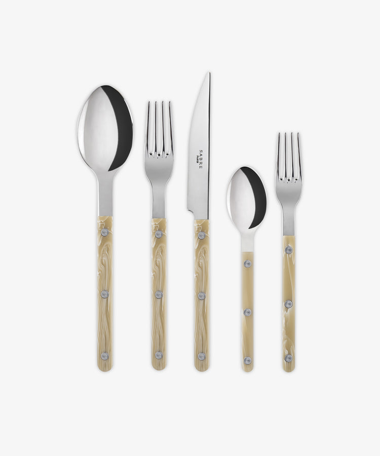 The Bistrot 5 Piece Cutlery Set features beige horn-handle flatware arranged in Parisian bistro style: a dinner fork, salad fork, dinner knife, tablespoon, and teaspoon.