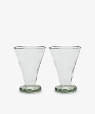 Six handmade Elodie Footed Wine Glasses, crafted from recycled glass with wide mouths and rounded bases, are arranged side by side on a white background.