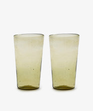 A set of six Elodie Water Glasses, handblown in Morocco from translucent yellow-tinted recycled glass with a slightly irregular shape, displayed on a white background.