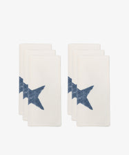 The Nova Napkin, Set of 6, features ivory linen napkins with a blue star on one corner, arranged in pairs against a white background—ideal for stylish table settings.