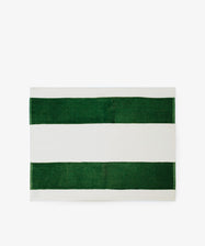 The Riga Placemat, Set of 6, features a bold design with two wide green stripes and a central white stripe on a white background. Pair with Riga Napkins for a coordinated table setting.
