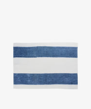 Riga Placemat. Folded white linen mat with thick indigo stripes.