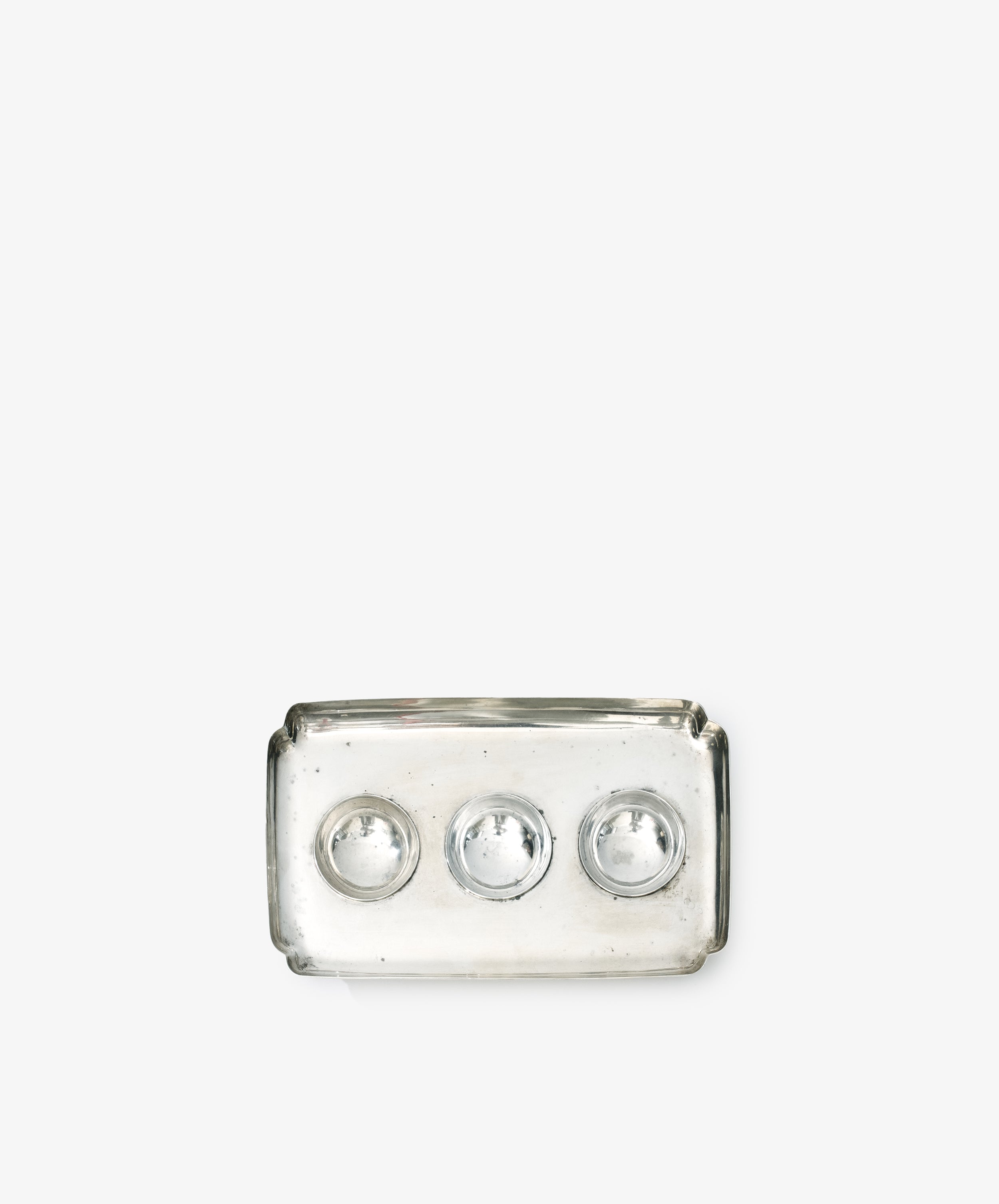 A Vintage Silver Inkstand Base with a rectangular clear glass tray featuring three circular indentations, inspired by vintage collections, displayed on a plain white background.