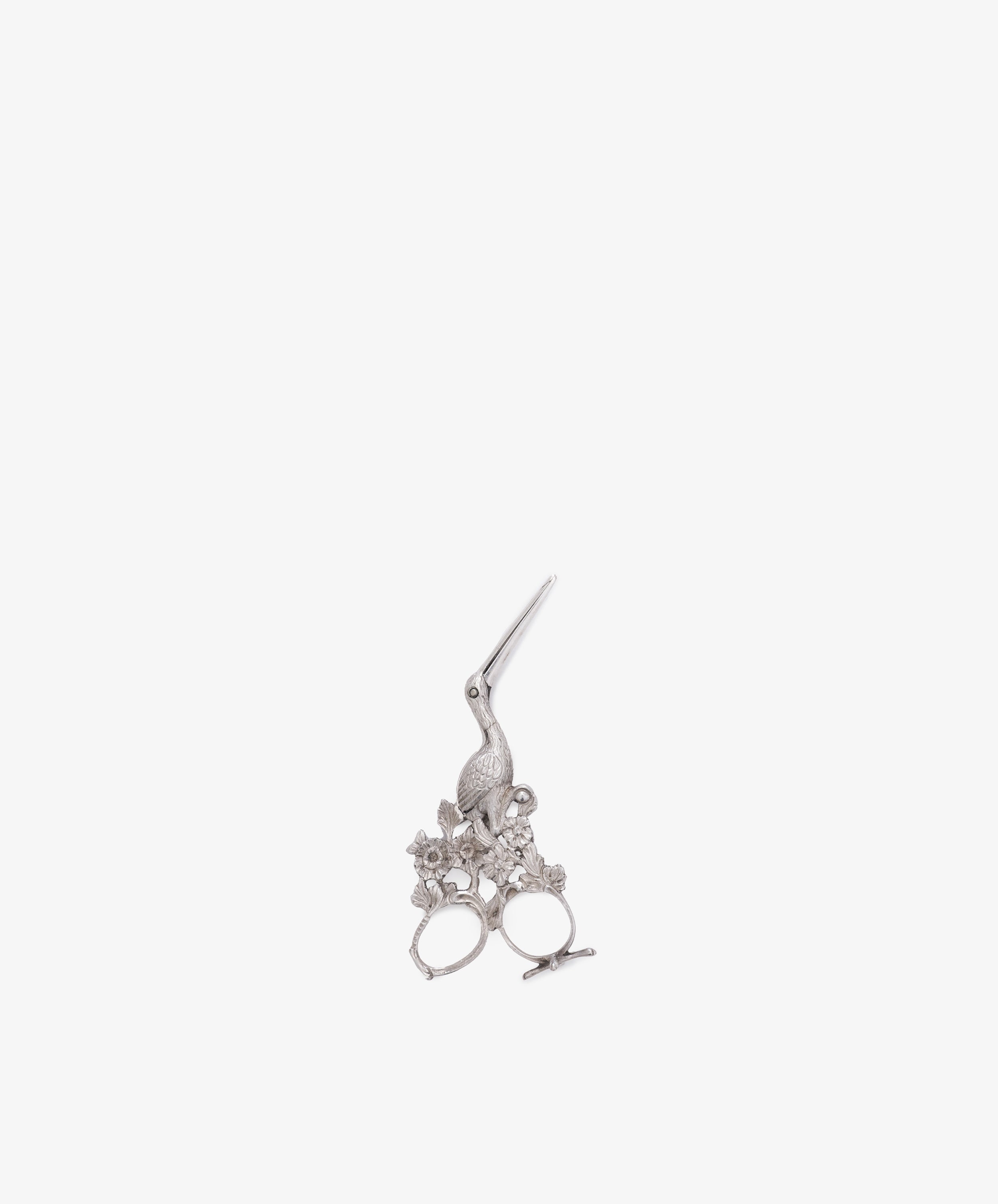 Vintage Dutch Silver Ribbon Nips shaped like a bird, inspired by stork scissors, with floral handle details, shown on a plain white background.
