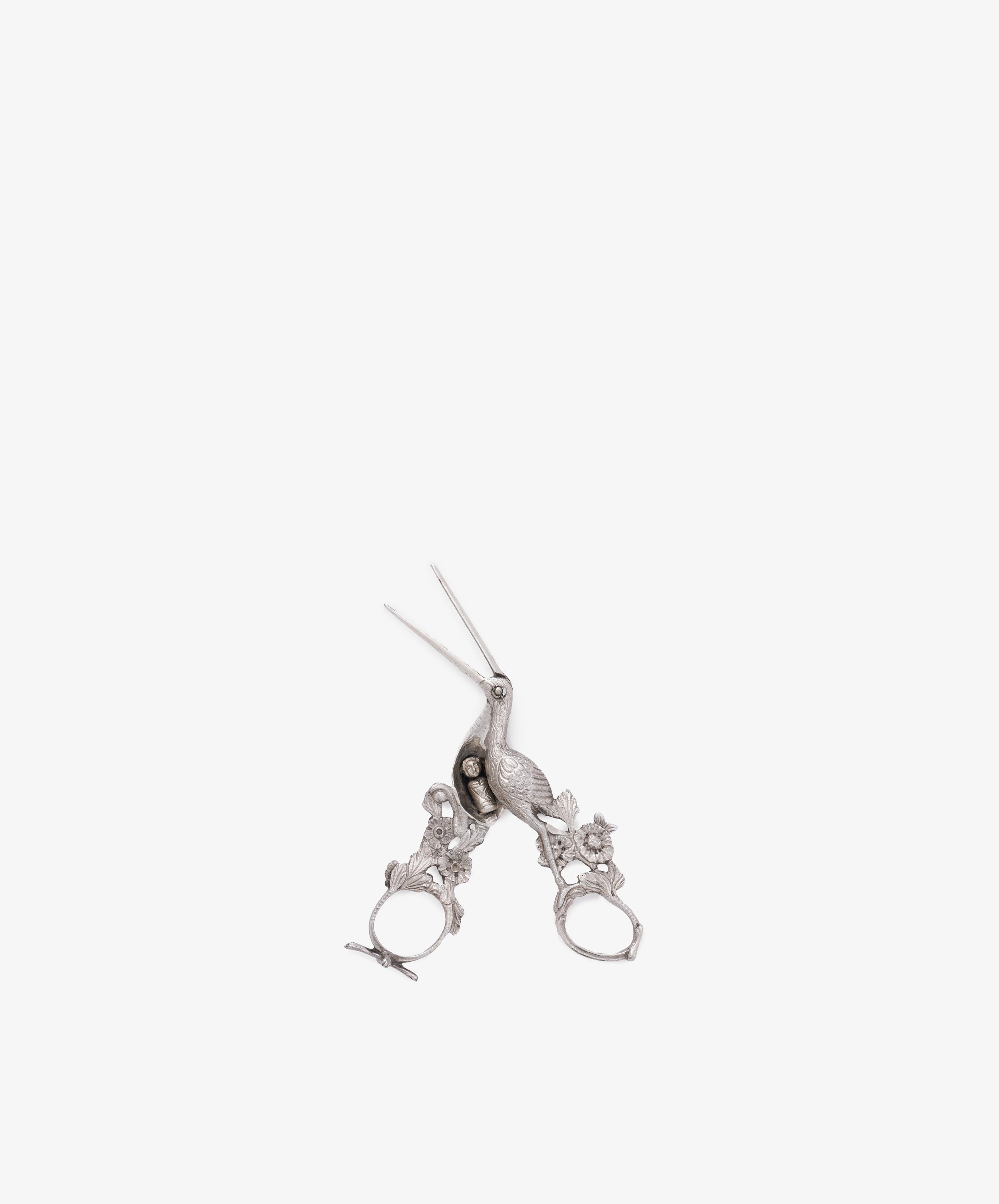 The Vintage Dutch Silver Ribbon Nips are ornate, silver-colored scissors inspired by vintage sewing tools, with intricate handle details, displayed on a white background.