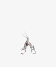 The Vintage Dutch Silver Ribbon Nips are ornate, silver-colored scissors inspired by vintage sewing tools, with intricate handle details, displayed on a white background.