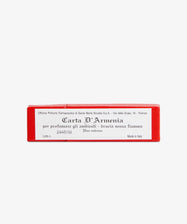 A small red box labeled Armenia Paper displays product and manufacturer info in Italian and English. It contains perfumed paper with a resinous aroma, shown against a white background.