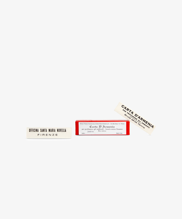 A rectangular red box labeled Armenia Paper - Small Box contains two white perfumed slips, one reading Officina Santa Maria Novella Firenze and the other Carta D’Armenia, both known for their distinctive resinous scent.