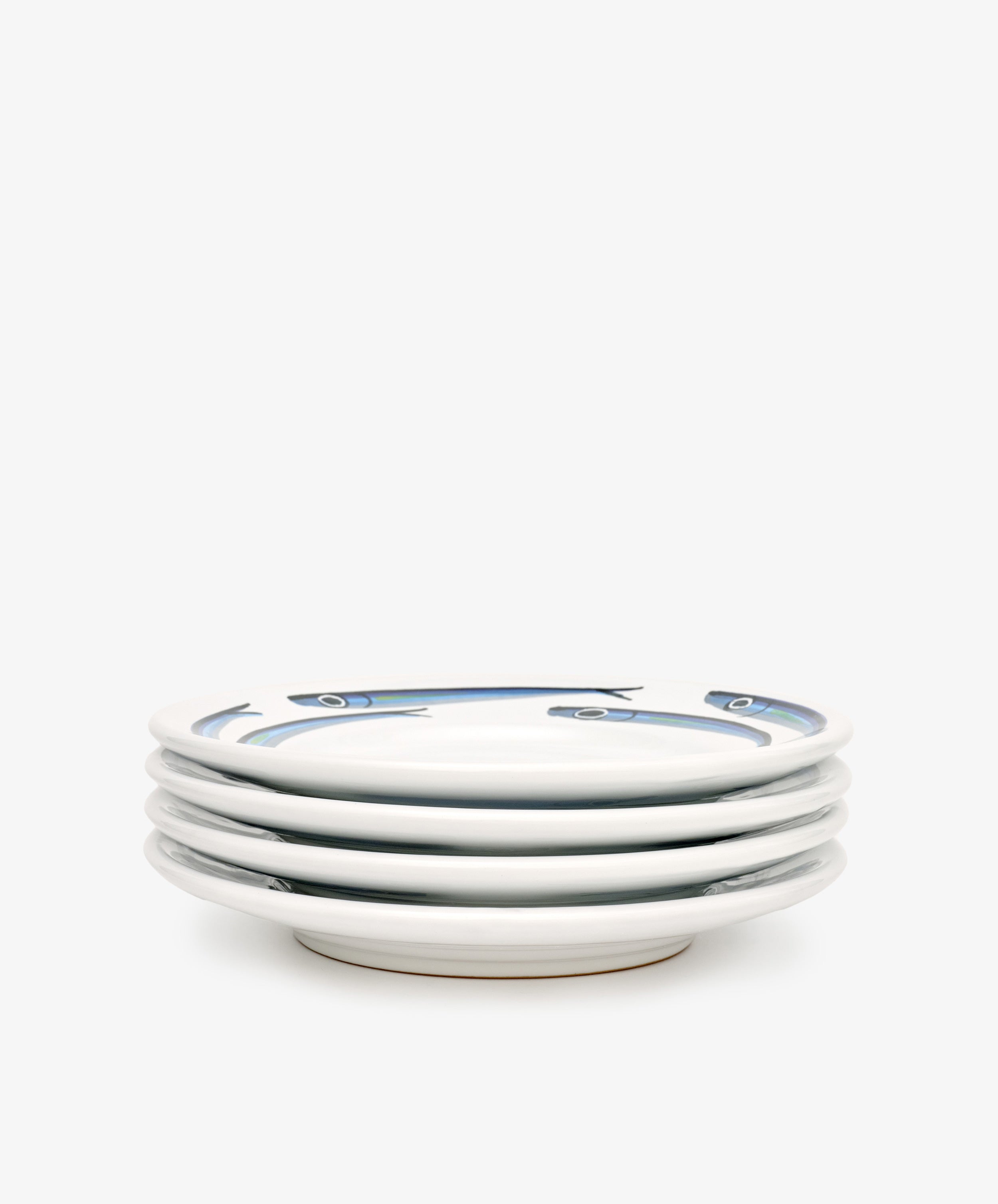 The Tommaso Small Plate, Set of 4, features hand-painted blue fish along the rims on a plain white background—evoking the charm of the Amalfi Coast.
