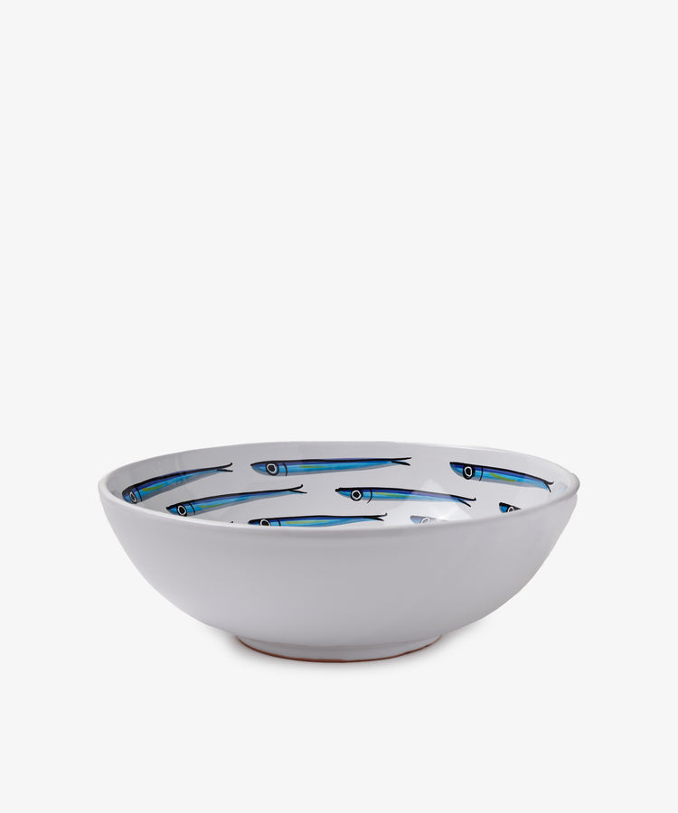 The Tommaso Salad Bowl is a white ceramic bowl adorned with blue sardine illustrations on the inside, evoking the charm of the Amalfi Coast, displayed against a plain white background.