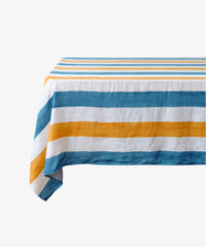 Striped Tablecloth by Summerill & Bishop. White linen cloth in blue and orange stripes draped over floating table.