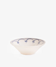 The Arco Serving Bowl is a white ceramic bowl with a flared rim, showcasing a simple blue scalloped pattern inspired by traditional Portuguese design on a plain white background.