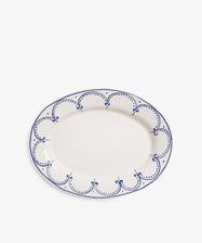 Arco Oval Serving Platter. Overhead view of large white glazed ceramic plate with handpainted blue border design.