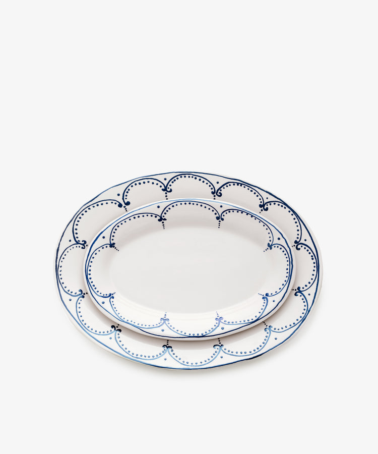 Two sizes of Arco oval serving platters, nested on top of one another.